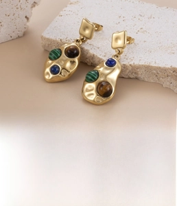 Detail of gold-plated stainless steel teardrop earrings with inset colored zircon gems