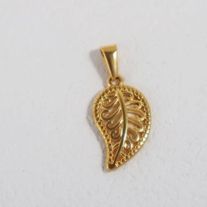 Detailed view of a 24K gold plated leaf pendant with hollowed filigree design
