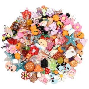 Close-up of colorful resin DIY charms in various food, animal, and plant shapes