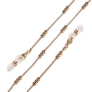 Detail of golden beaded metal chain for glasses and masks with white silicone loops