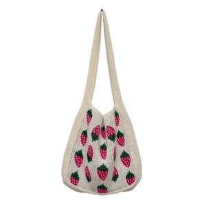 Knitted strawberry tote bag in off-white handmade style on a white background