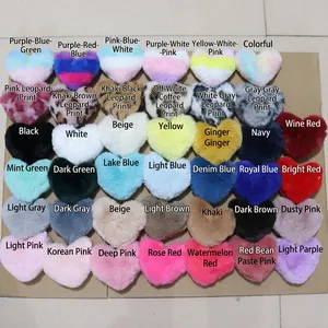 Plush heart-shaped faux fur keychains in various vibrant colors and leopard patterns