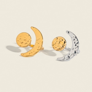 Detail of sun and moon open rings in gold and silver finish with hammered texture