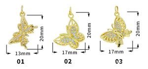 Detailed view of micro-pave butterfly charms in gold with white zircon and size markings