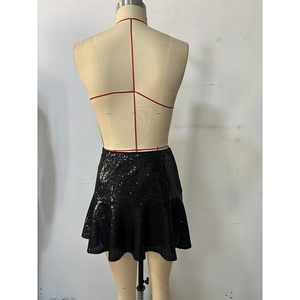 Macro detail of high-waist black sequin mini skirt with shimmering A-line ruffle hem