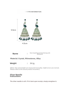 Detailed view of peacock tassel earrings with crystals and size markings of 9.9cm by 4.5cm