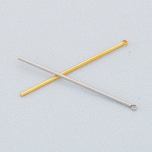 Detail of cylindrical stainless steel bar pendants in gold and silver for DIY jewelry