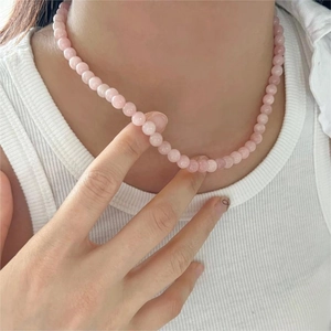 Minimalist 925 sterling silver necklace featuring pink crystal beads worn on a neck