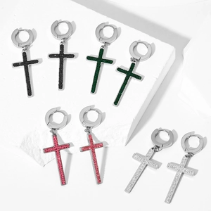 Detail of cross hoop earrings with multi-colored crystals on white stone display