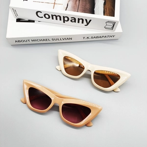 Retro cat-eye sunglasses in cream and light brown frames with thick vintage design