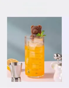 Detailed close-up of a 3D bear-shaped ice cube in a drink glass for chilled beverages