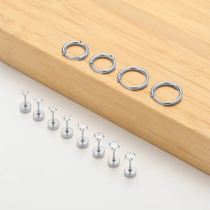 Minimalist silver stainless steel earring set with 12 pieces featuring studs and hoops