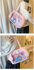 Detailed view of pink plush ita bag featuring a large transparent PVC window and bunny ears