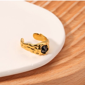 Detail of vintage gold lava texture ring featuring an inlaid black geometric zircon stone