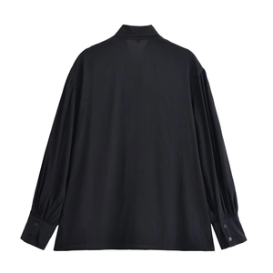 Women's black long sleeve shirt with pleated cuffs and stand collar, back view