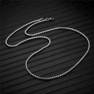 Close-up of silver stainless steel box chain necklace with a lobster clasp detail