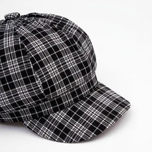 Classic black and white checkered newsboy cap with wide brim and octagonal crown structure