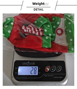 Close-up showing a 28g lightweight snowman wine bottle cover on a digital scale