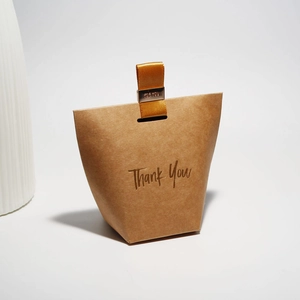 Trapezoidal brown kraft paper gift box with gold Thank You text and ribbon handle