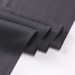 Macro shot of dark grey cashmere-like scarf fabric showing thick texture and weave details