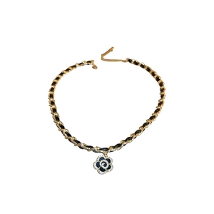 Elegant gold plated camellia necklace with black leather chain and sparkling zircons