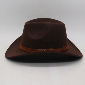 Detailed view of a brown suede cowboy hat with a leather strap and metal buckle detail