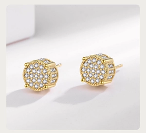 Macro detail of gold-plated hip hop stud earrings with micro-pave white cubic zirconia