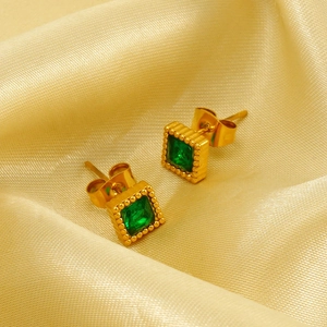 Square green zircon gold stud earrings with milgrain edge on luxury silk background
