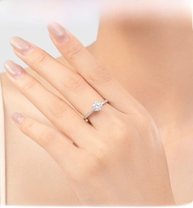 Macro view of a classic six-prong silver engagement ring with sparkling zircon inlays