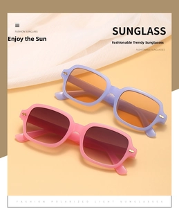 Close-up of retro rectangular sunglasses with metal rivets and tinted lenses