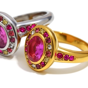 Macro shot of 18K gold plated ring with a large pink oval gemstone and colorful zircons