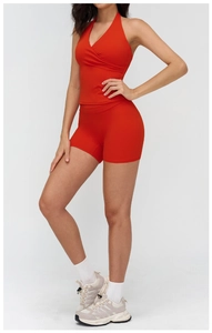 Detail of red hollow back yoga set featuring a halter crop top and high-waisted shorts