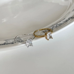 Detail of minimalist 925 silver open rings with rectangle zircons in gold and silver
