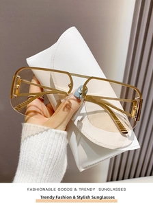 Close-up of semi-rimless pilot sunglasses with golden frame and textured eyewear case