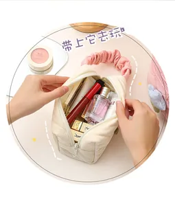 Spacious corduroy cosmetic bag interior showing storage for various makeup products