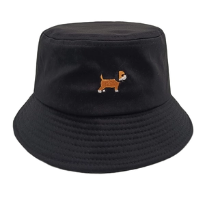 Close-up of cute dog embroidery on a black cotton bucket hat with a wide brim