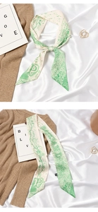 Detail of elegant cream and green landscape print silk scarf showing fine texture