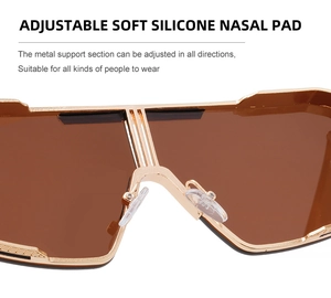 Detail of adjustable silicone nose pads on gold metal punk sunglasses with brown lenses