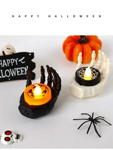 Detail of Halloween LED skull hand candle holders in black and white for party decor