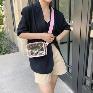 Transparent PVC crossbody bag with wide pink strap and floral scarf shown on a model