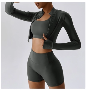 Detail of high-waisted shorts and thumbhole cuffs on this charcoal grey yoga set