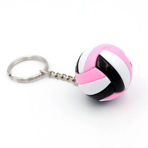 Close-up of a volleyball keychain with pink, white, and black PVC stitching pattern