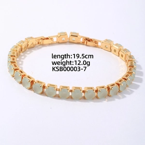 Detail view of gold-toned hip hop bracelet with green stones, 19.5cm length and 12.0g weight