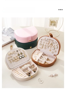 Close-up of portable semi-circular leather jewelry box with multi-compartment interior storage