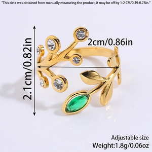 Macro detail of adjustable gold titanium ring with green gems and leaf design