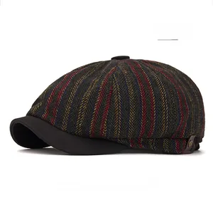 Detail view of herringbone newsboy cap featuring vertical red and blue stripes and metal logo