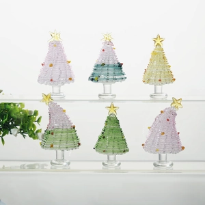Detailed macro view of handmade mini glass Christmas trees with colorful ornaments