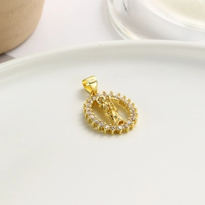 Elegant gold oval pendant necklace with zircon halo and religious figure on white plate