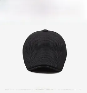 Detailed close-up showing the black waffle knit texture and fabric of this men's winter cap