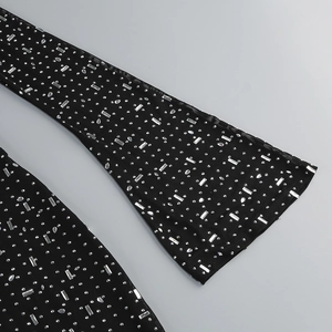 Detail of black mesh fabric with sparkling silver rhinestones and sequins on a dress